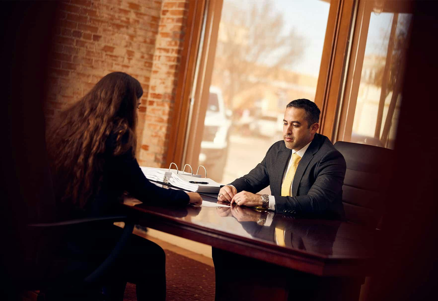 Brian Gutierrez sitting with client