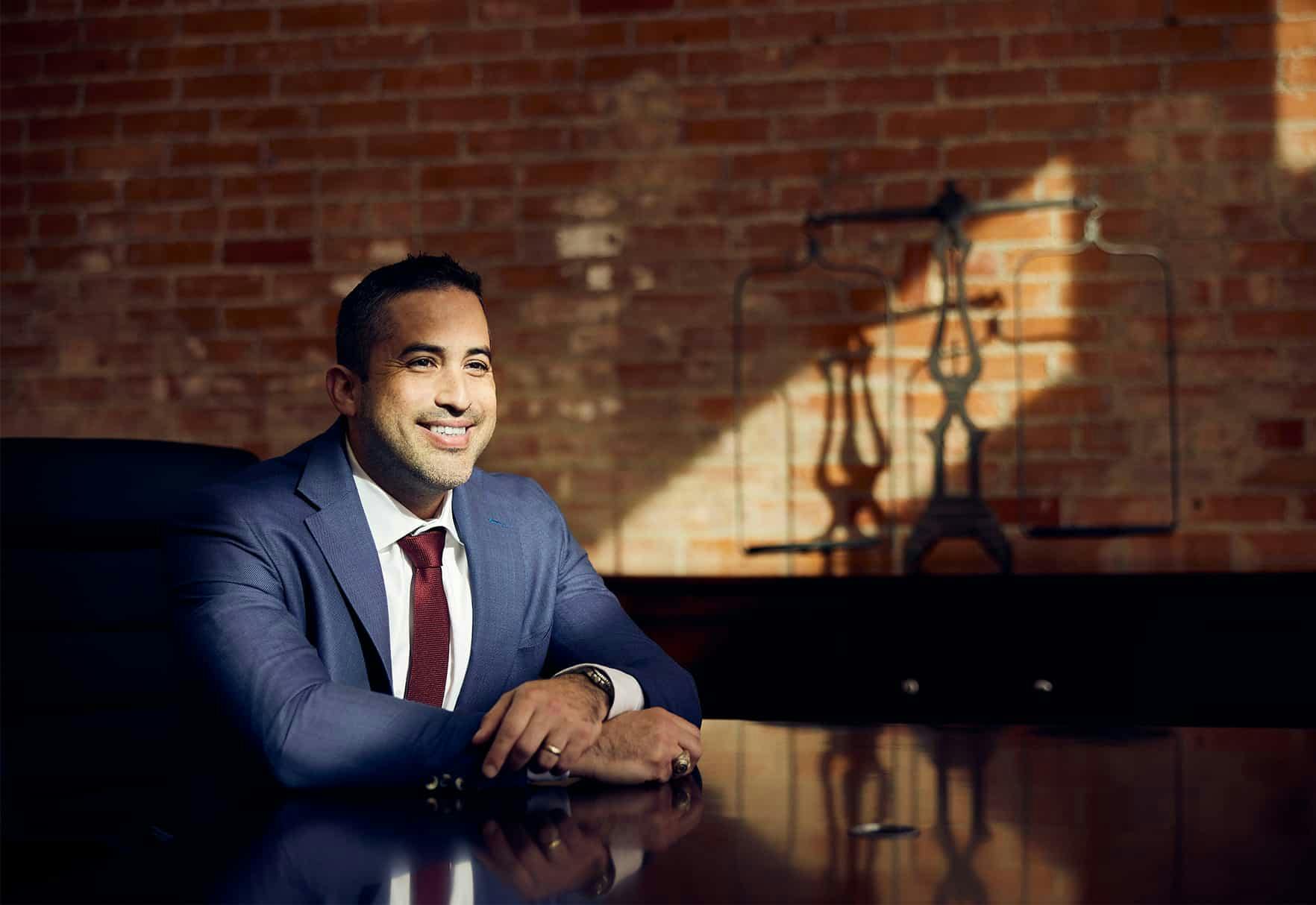 Attorney Gutierrez smiling while sitting at table