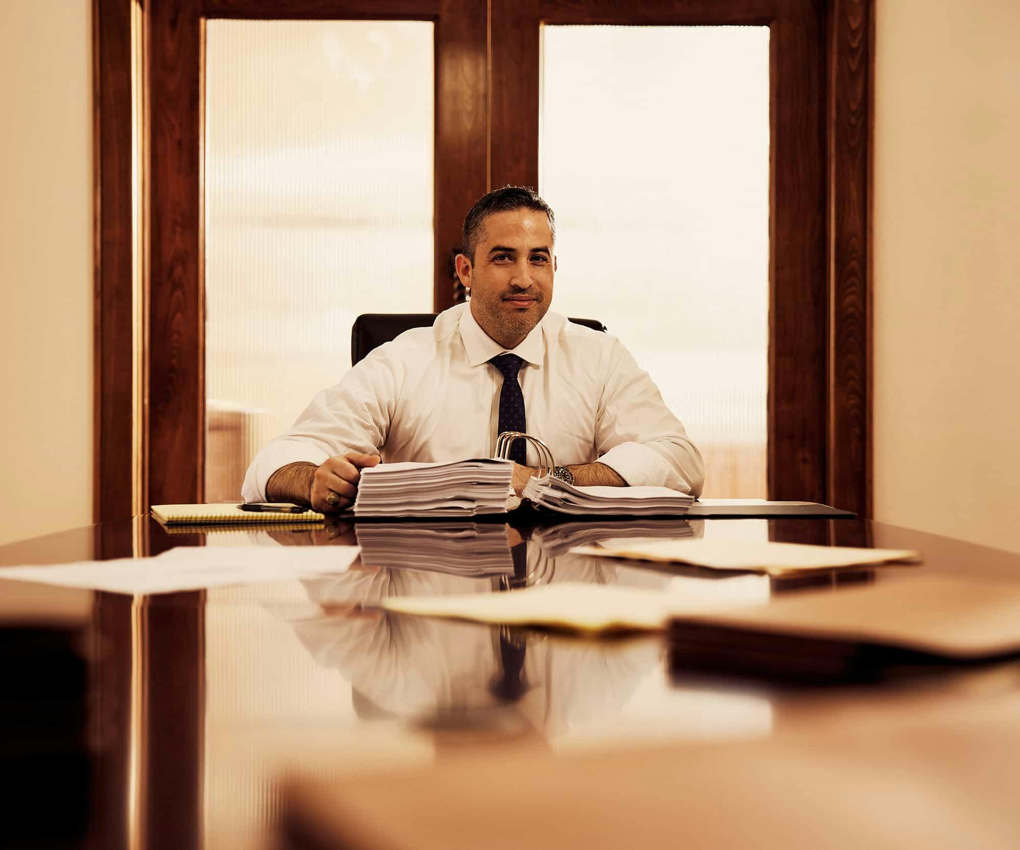 Brian Gutierrez sitting at a desk smiling