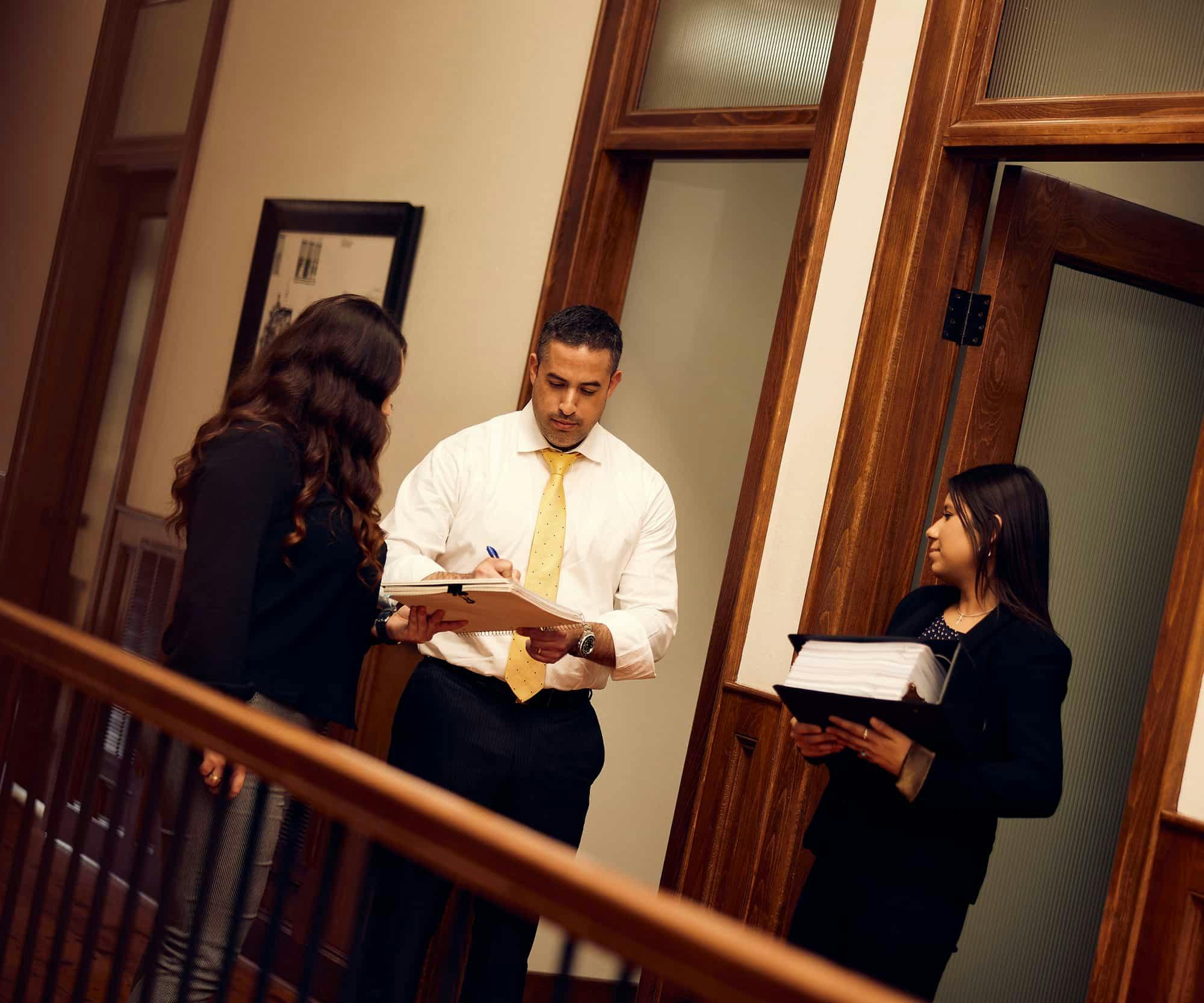 Brian Gutierrez speaking with legal assistants