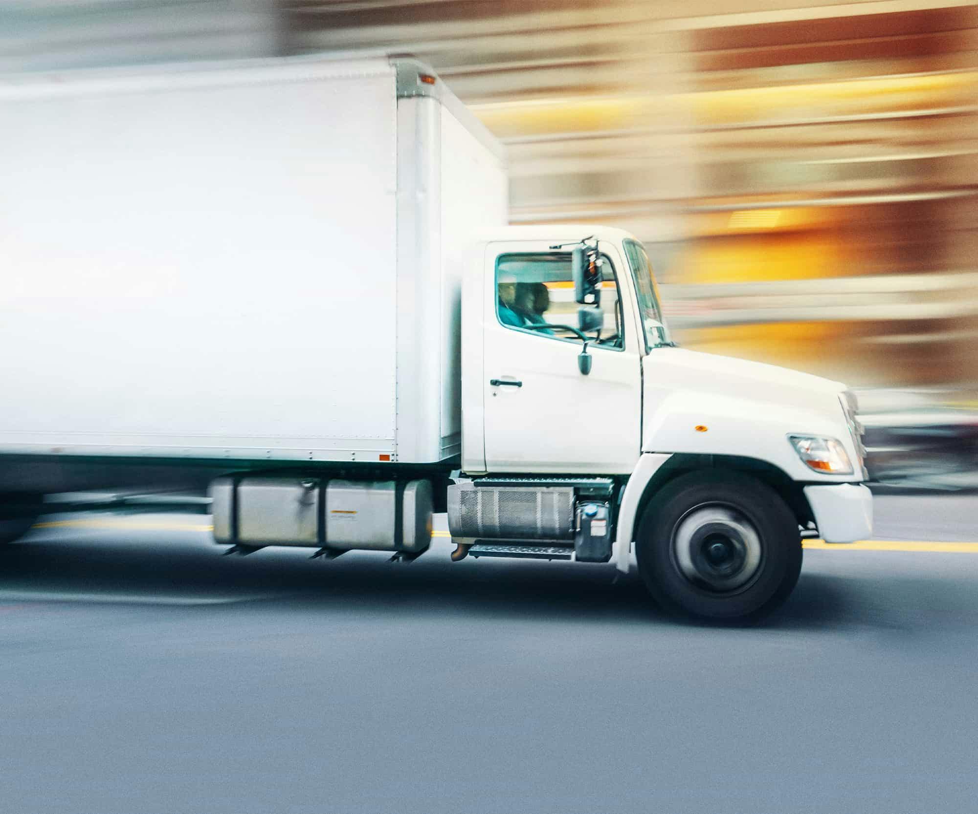 Delivery truck driving down a city street