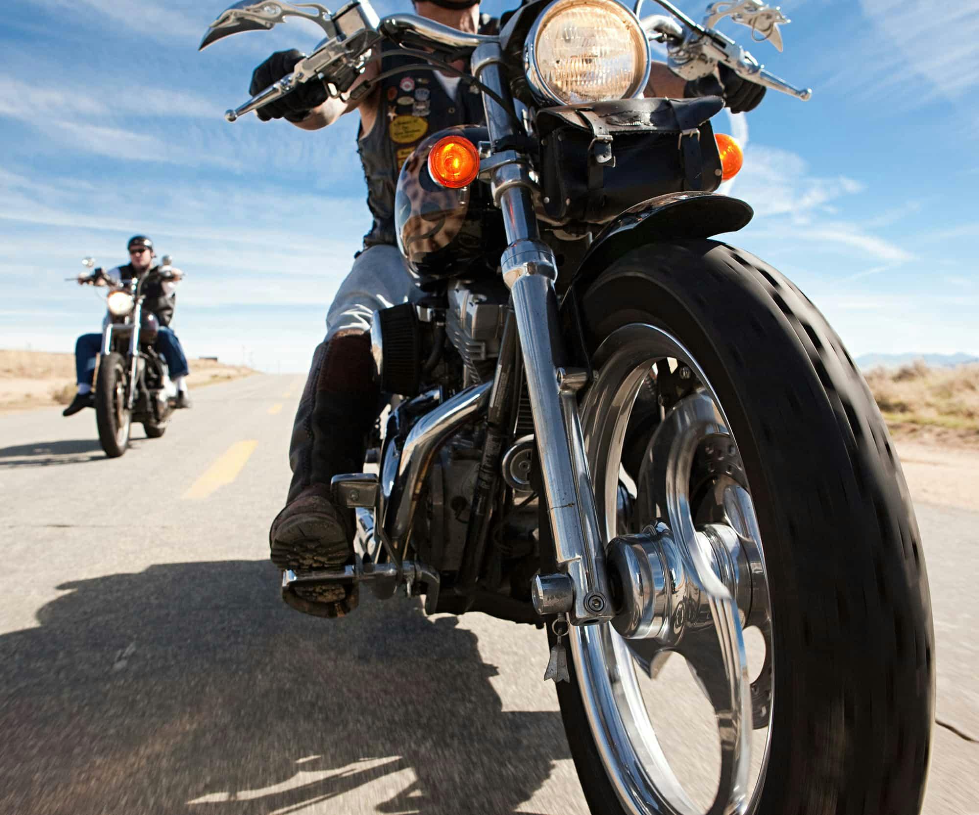 A motorcycle driving down the road