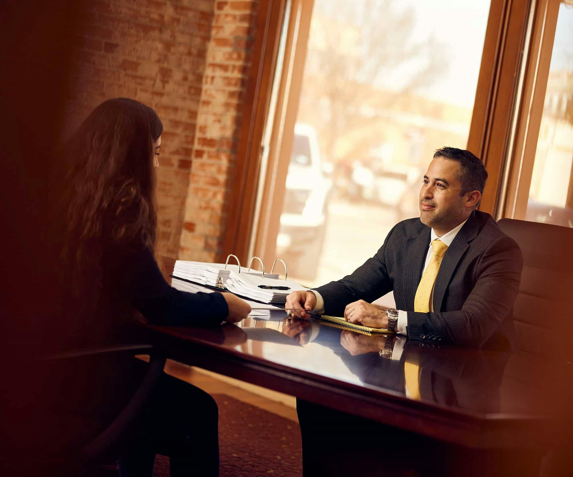 Brian Gutierrez sitting with client