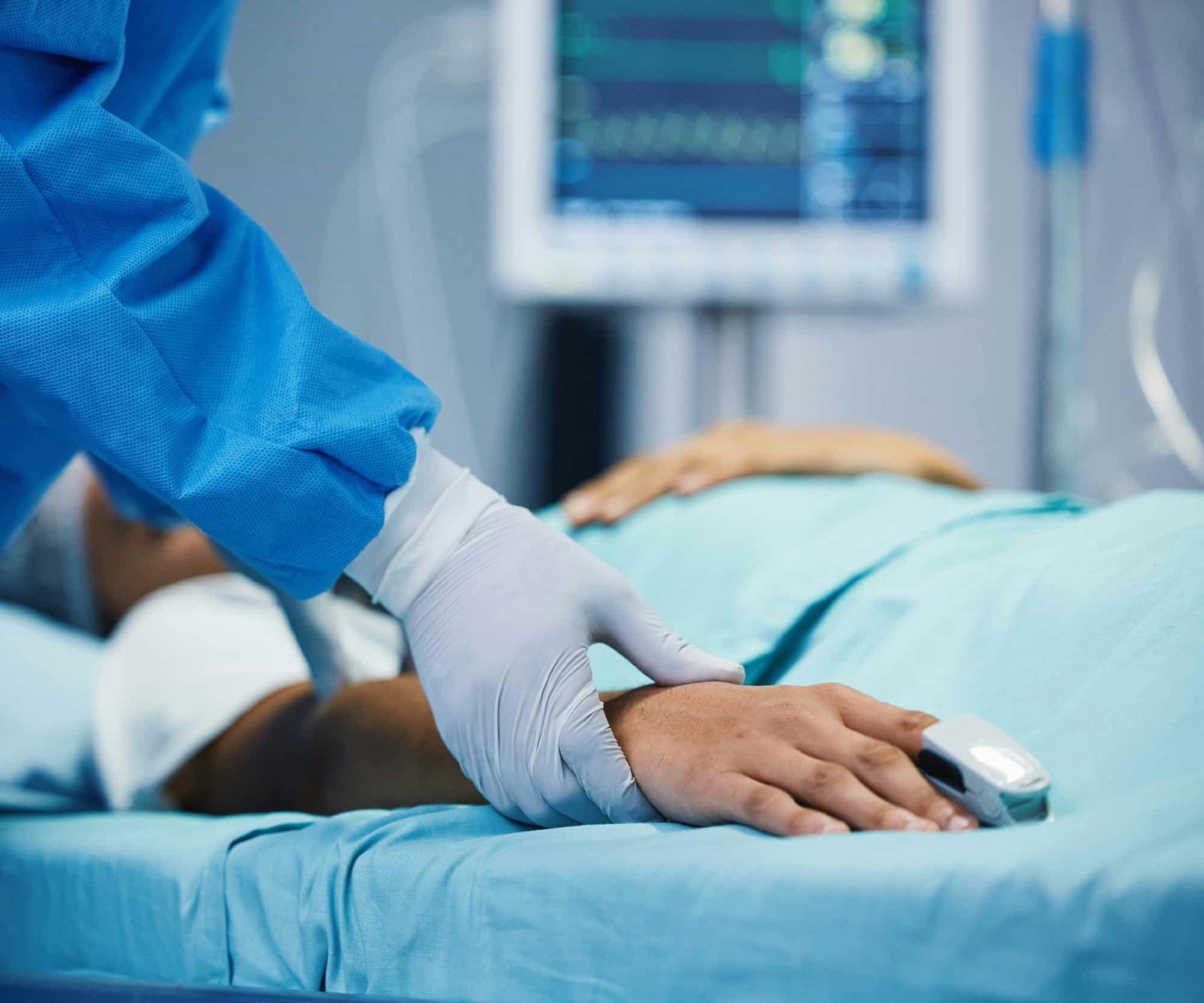 A doctor checking on a patient in the hospital bed