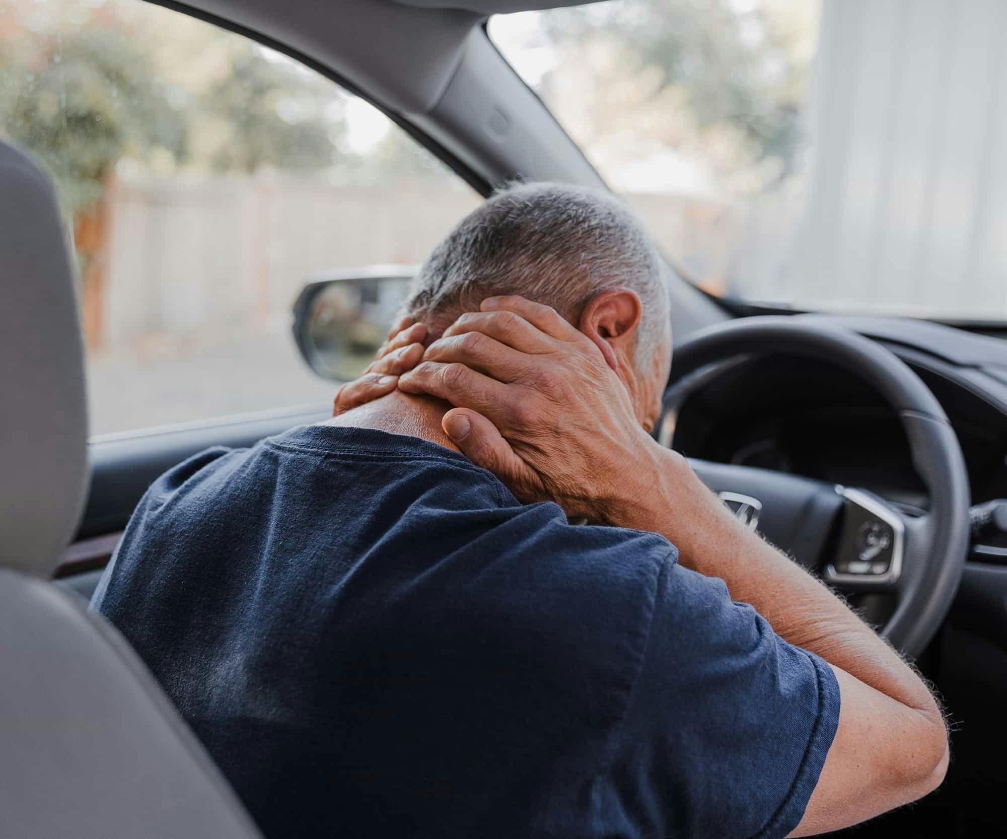 Man holding neck after accident