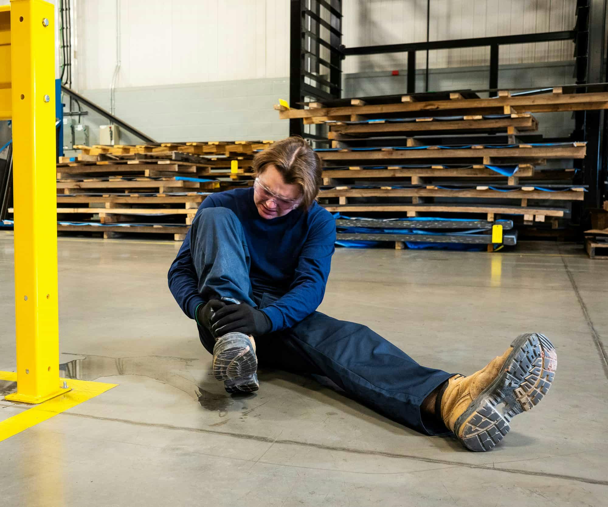 Man holding ankle after falling