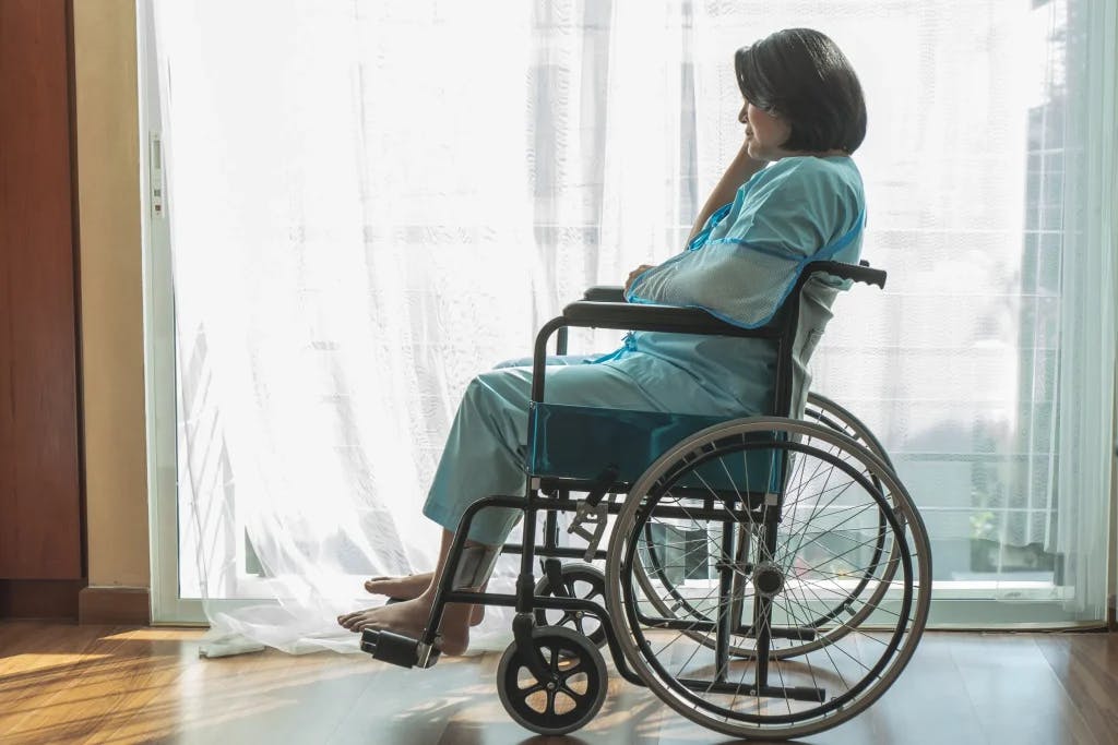 A woman in a wheelchair.