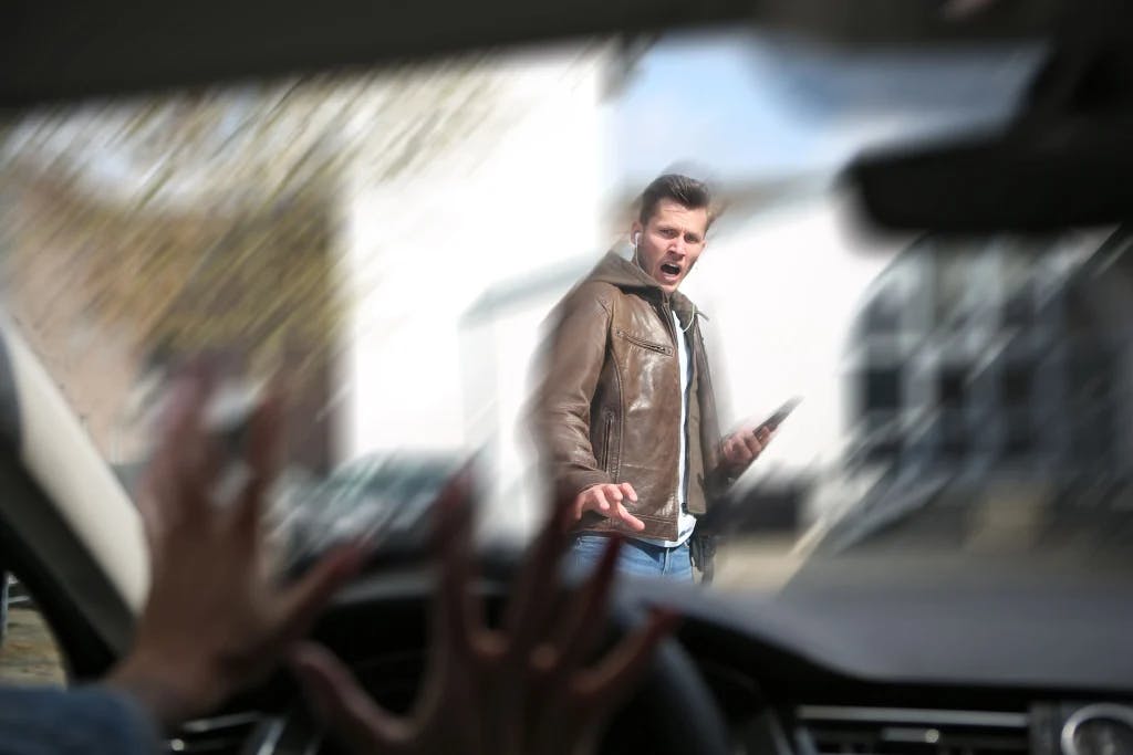 Someone driving and about to hit a pedestrian.