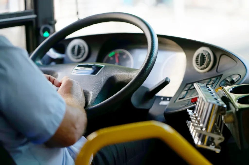 Someone driving a bus.