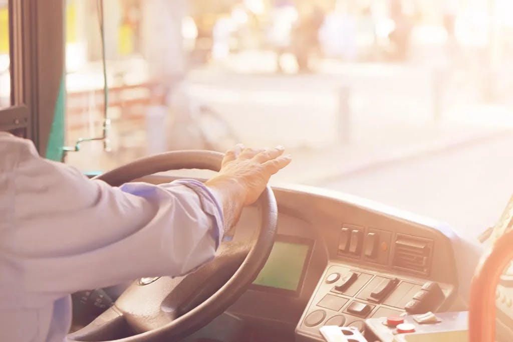 Someone driving a bus.