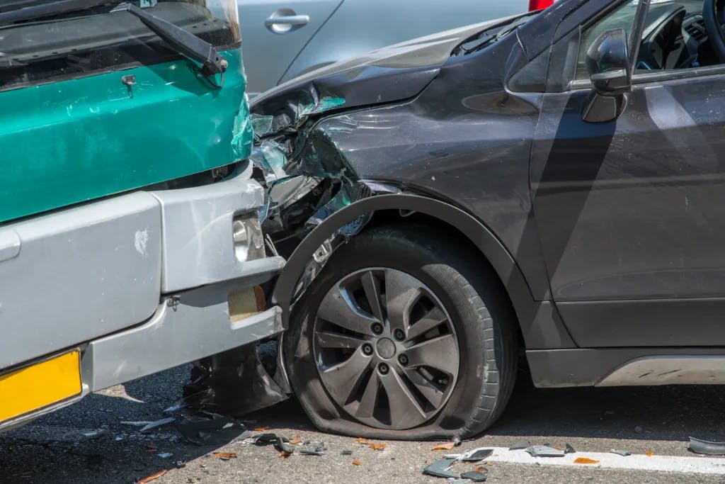 A bus and a car that have been in an accident.
