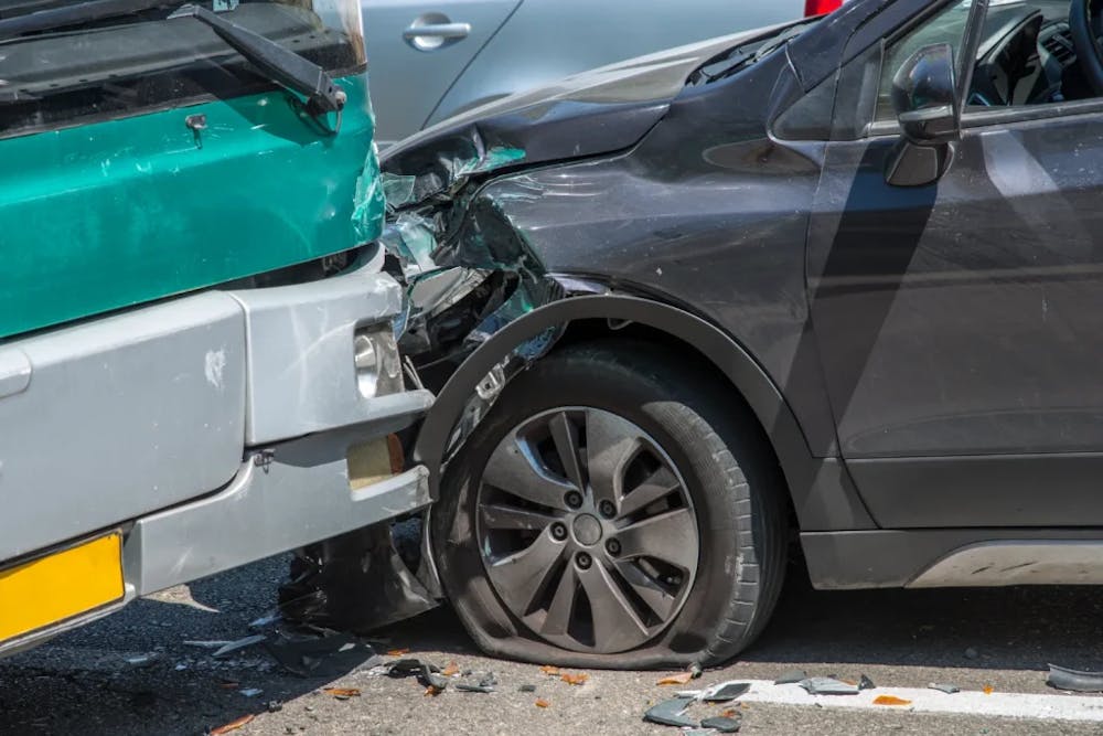 A bus and a car that have been in an accident.