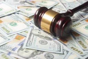 A gavel laying in money.