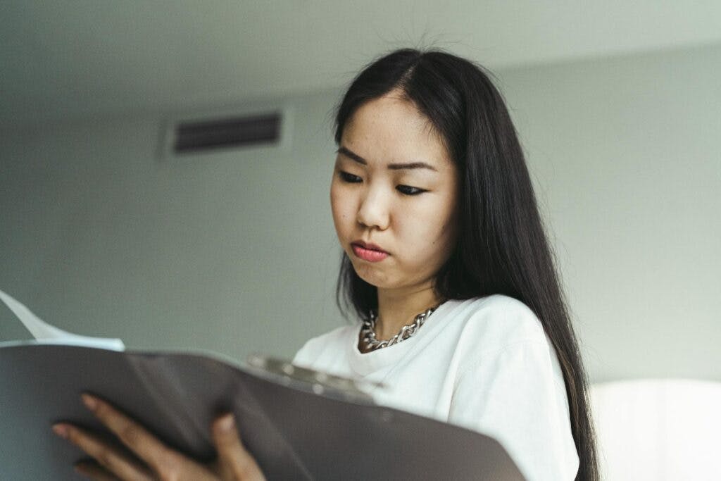 A disgusted woman looking at insurance settlement offer.