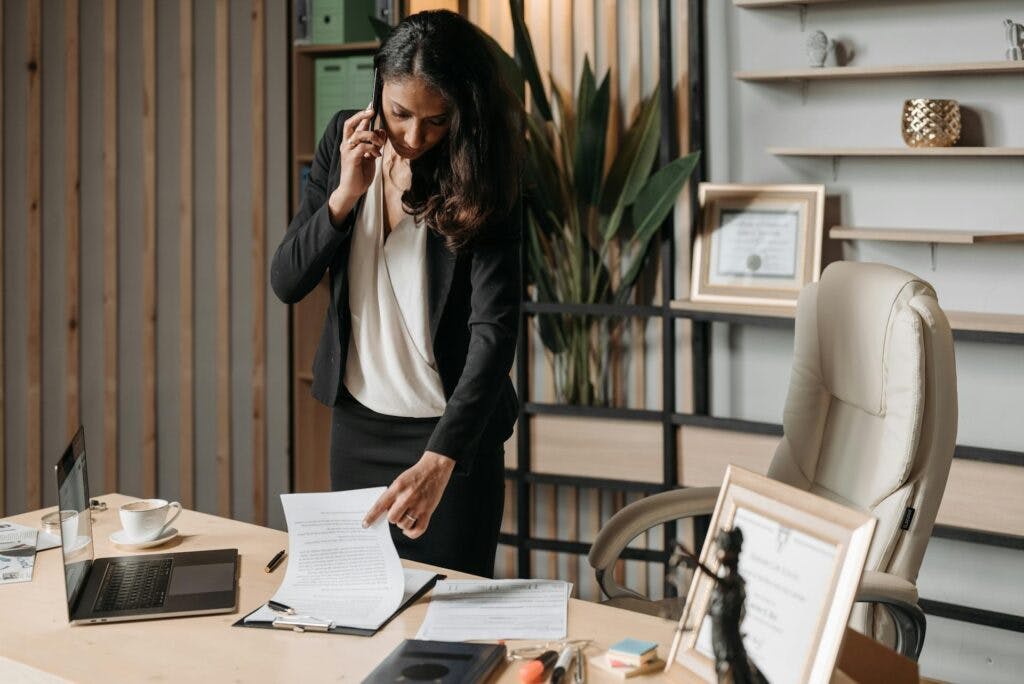 A business woman looking over insurance settlement paperwork.