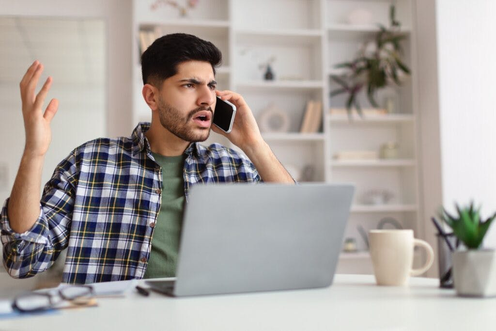 An angry man on the phone with insurance company.