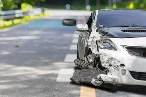 A completely totalled car that was hit by another vehicle. The driver is wondering how texas law impacts car accident settlements.