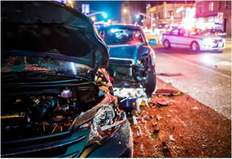 A car that has been in an accident and at night.