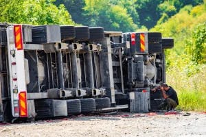 A semi truck lying on its side after hitting a car and losing control. The car's driver wonders if they can claim emotional distress.