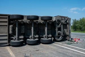 A commercial truck that has rolled over on the road and the driver is wondering if the location of the accident impacts the insurance claim.