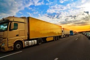 Commercial trucks driving along on the Texas highway. Some drivers wonder what evidence may be needed to support a truck accident claim.