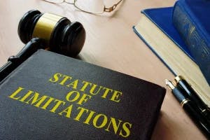 A book that says statue of limiations and a gavel.