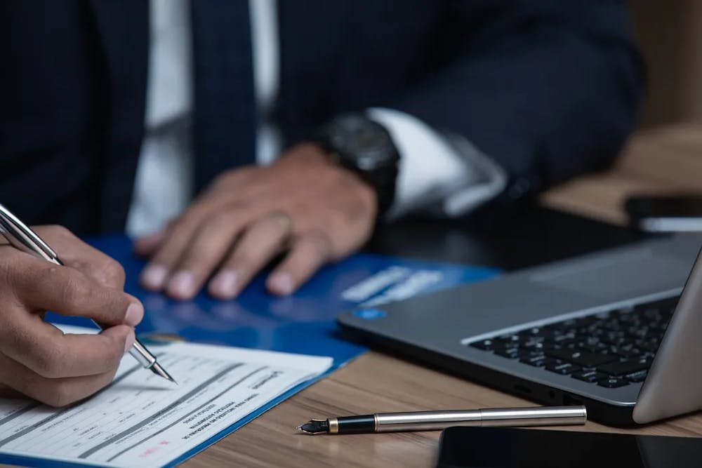 lawyer writing documents by his computer.