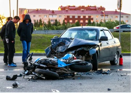 A motorcycle that has crashed into a car.