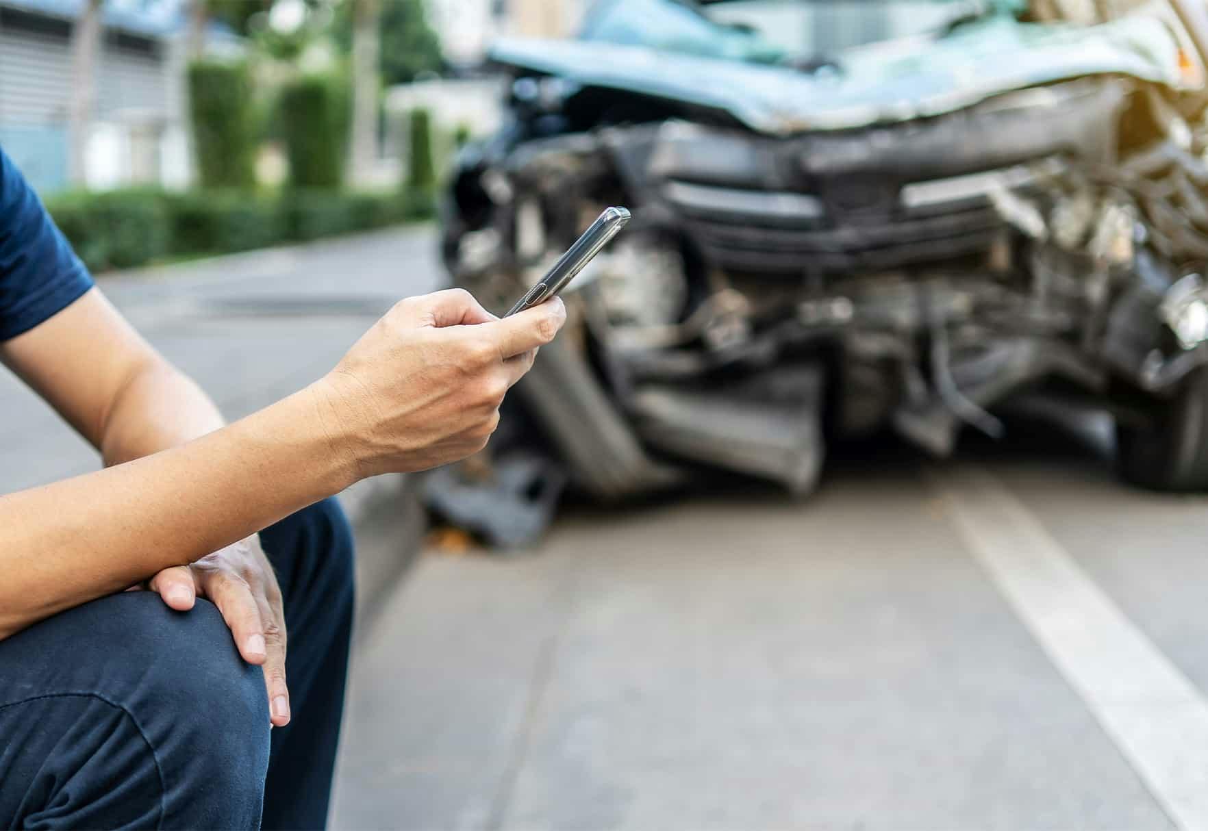 Person on their phone after an accident
