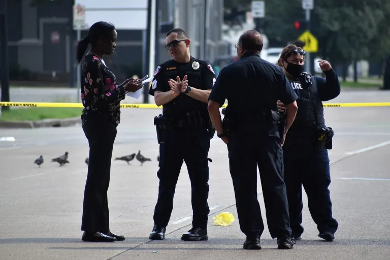 A group of policemen standing in the street