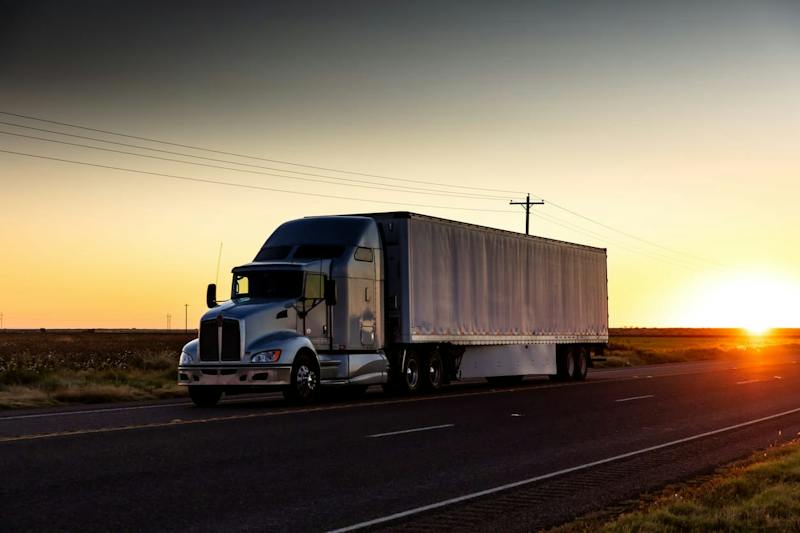 18-wheeler on the highway at sunset