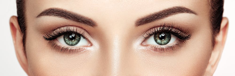 Close-up of eyes with smooth eyelids post gentle blepharoplasty technique.