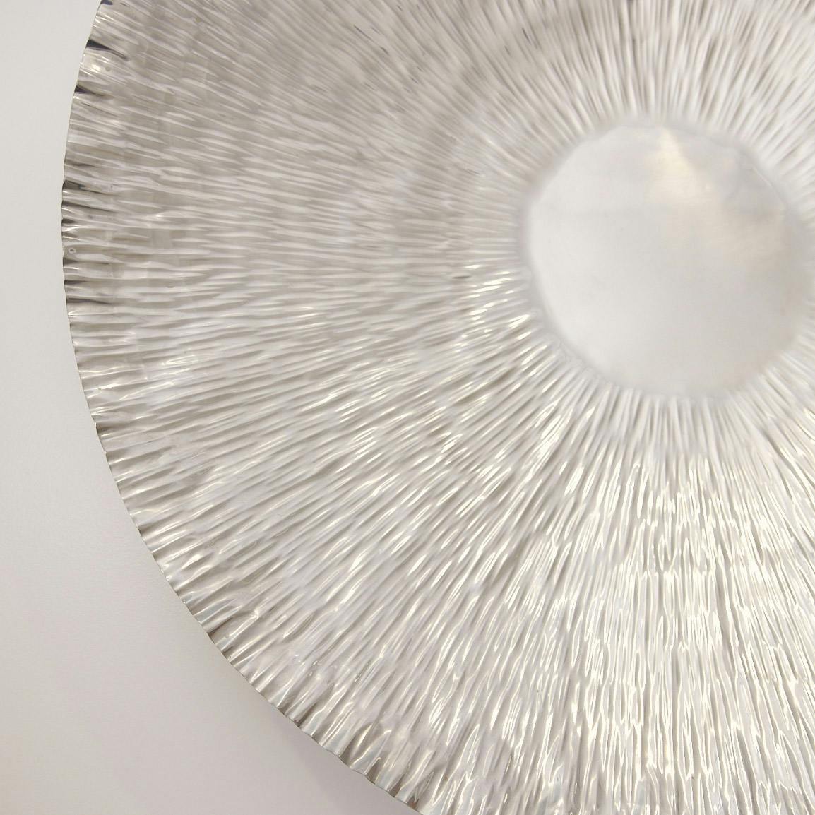 white round piece of art on wall