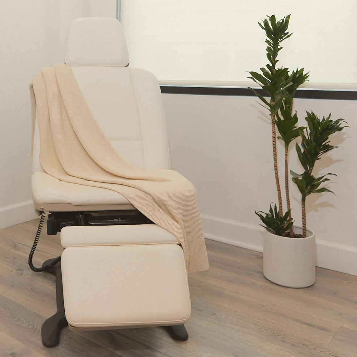 white office chair with blanket on it