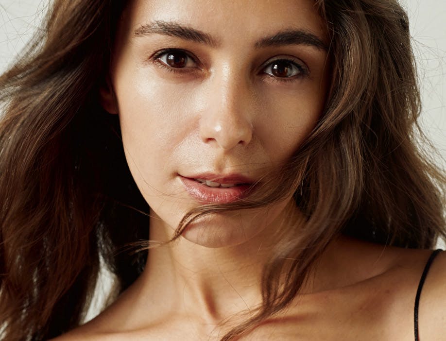 woman with wavy hair in front of her face