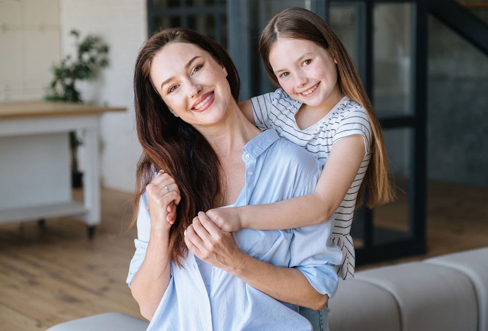 woman with her daughter hugging her from behind