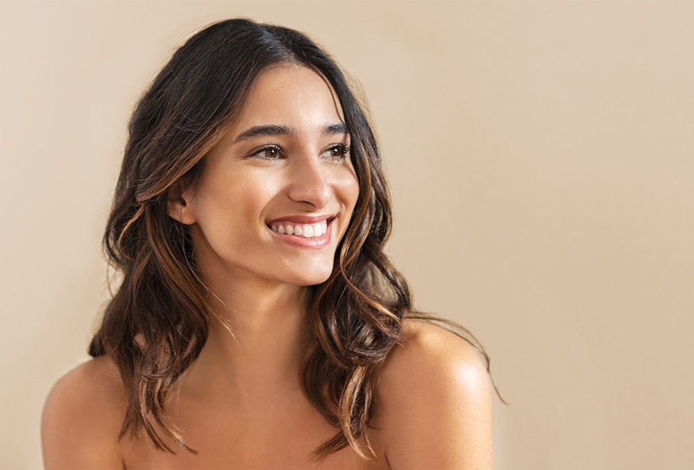 woman with brown hair smiling to the right