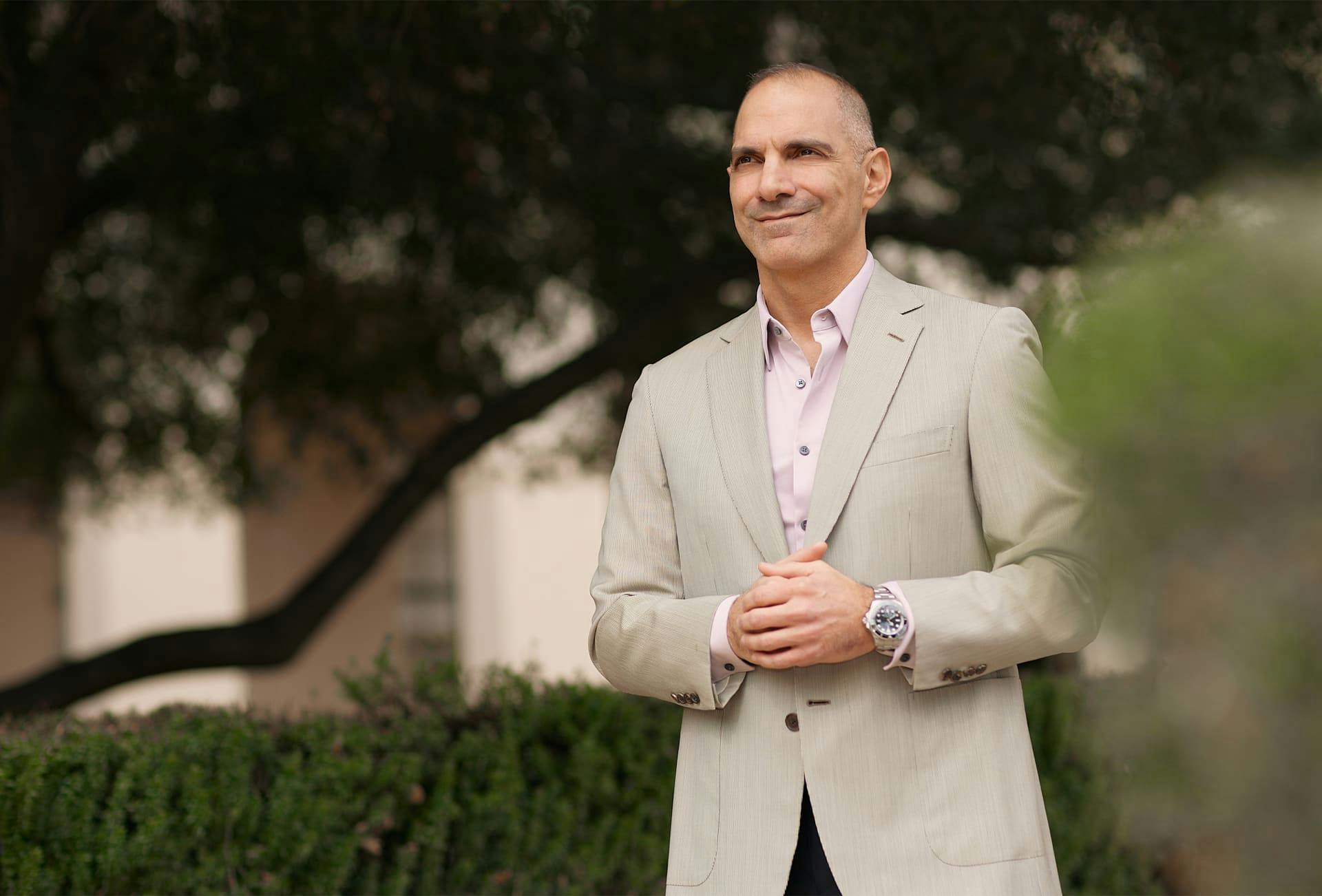 Dr. Panossian in beige suit standing outside
