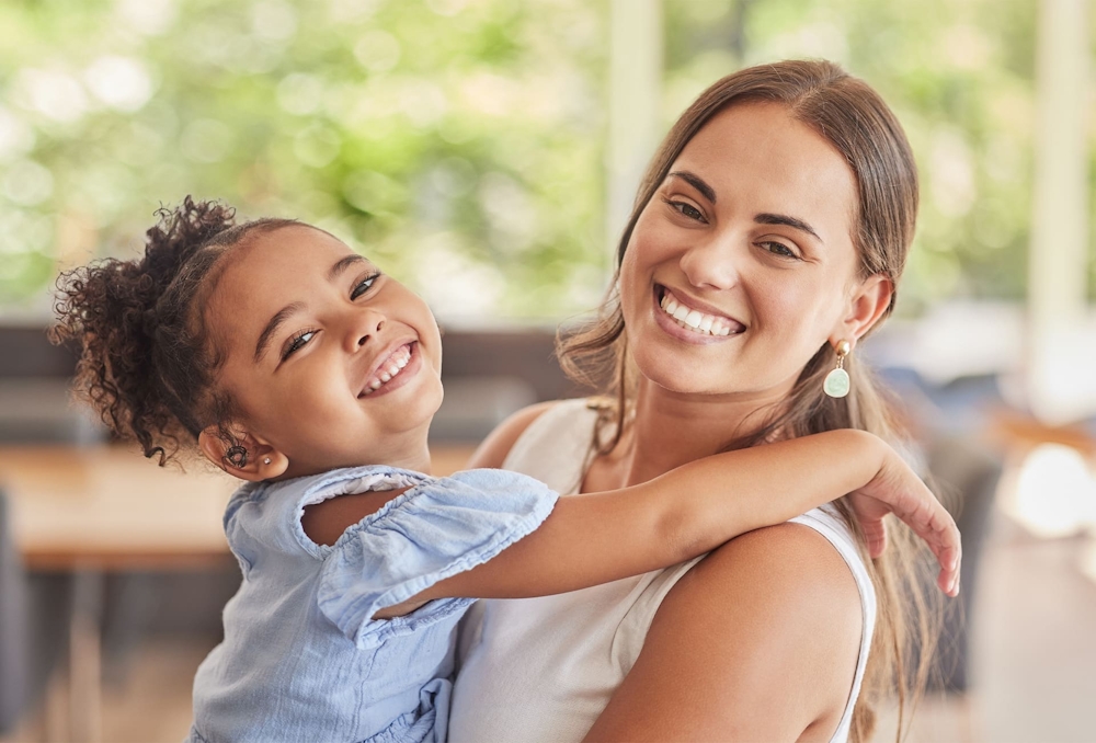 woman and toddler smiling together