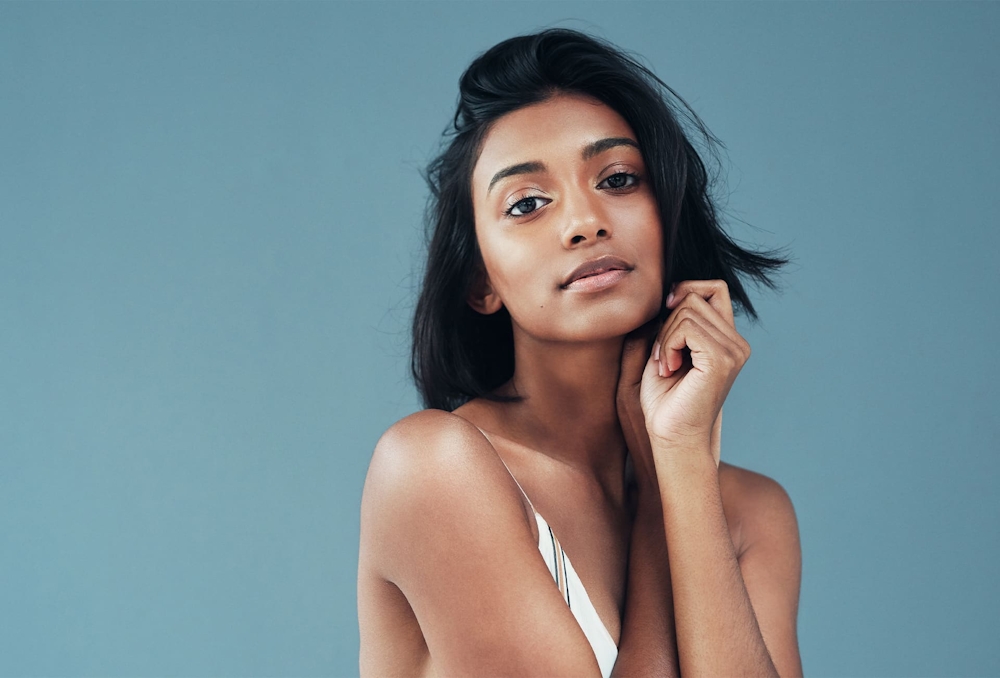 woman with short hair with hand touching hair
