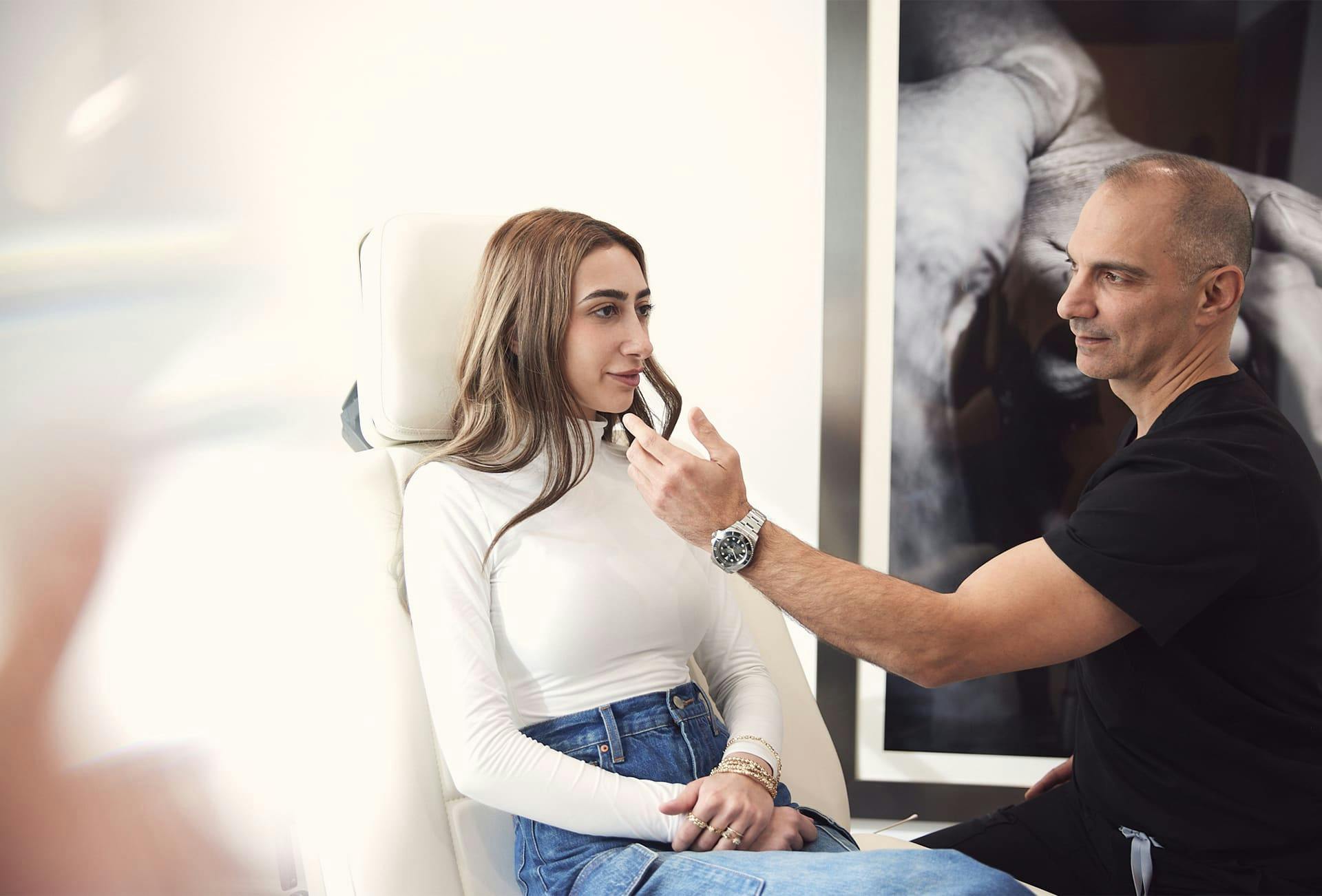Dr. Panossian with patient while she sits in chair