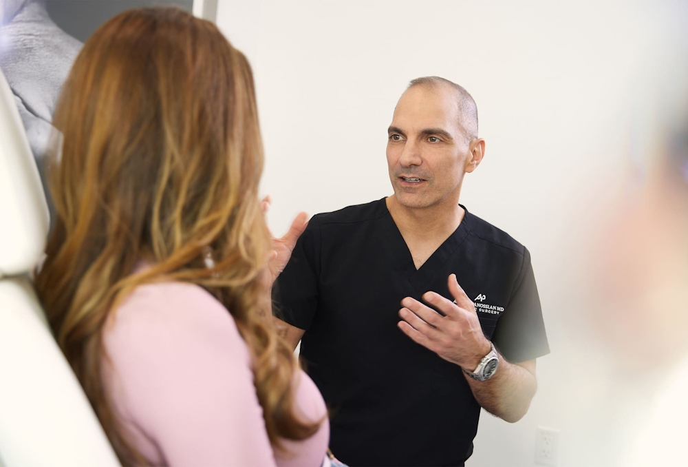 Dr. Panossian speaking to patient as she sits in chair