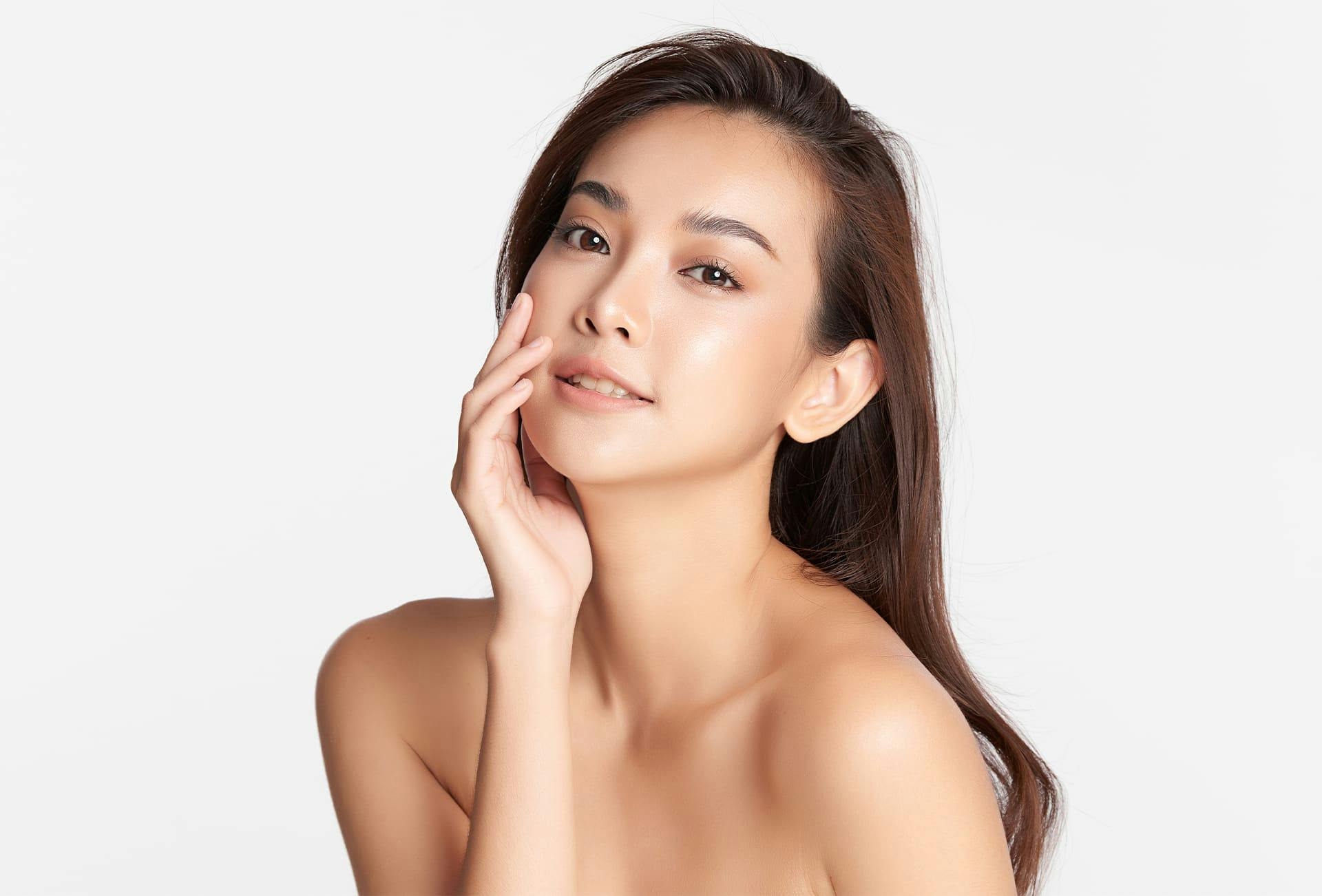 woman with hand on her face smiling