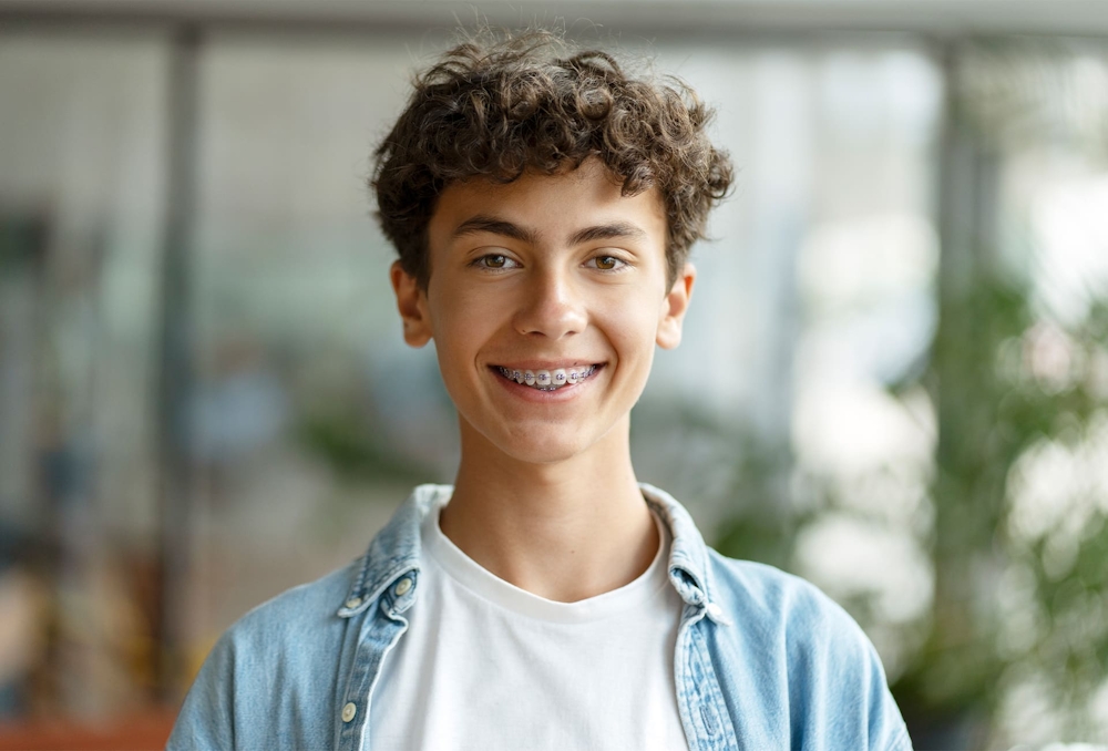 teenager with braces smiling