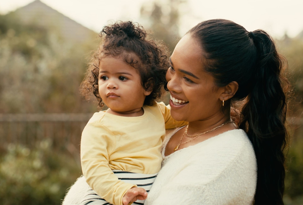 mother holding her baby smiling
