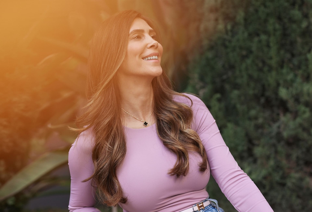 patient smiling in front of trees