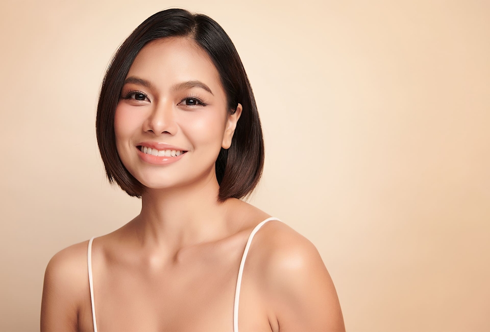 woman with short hair smiling forward