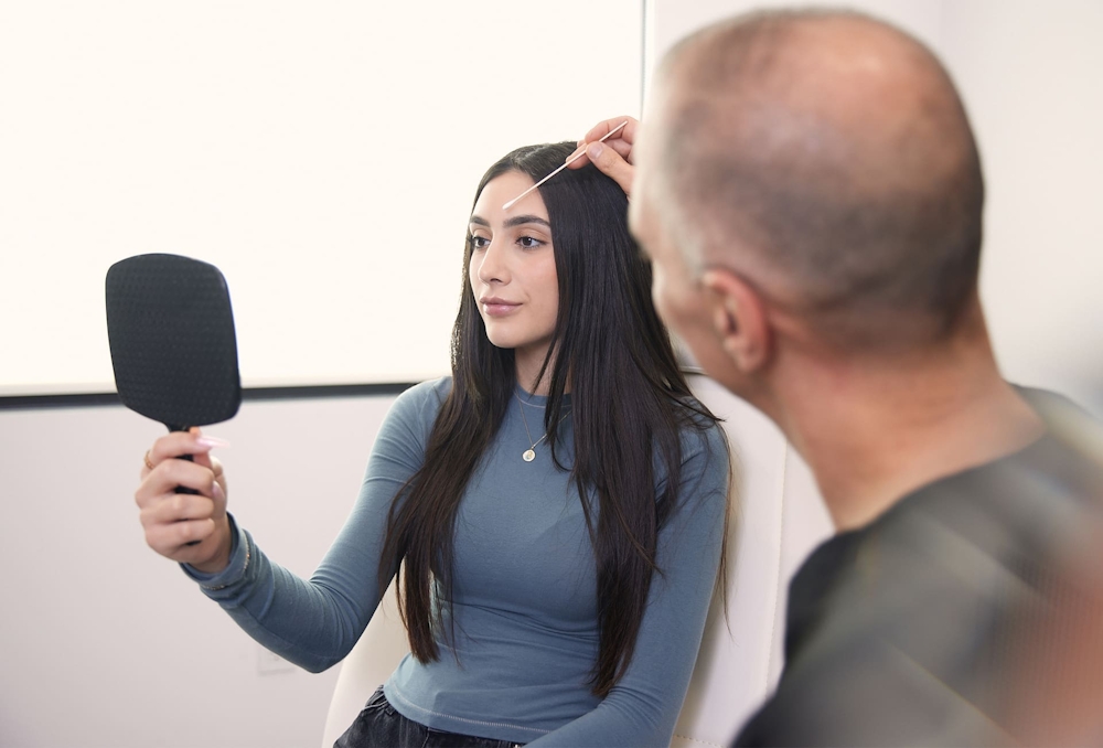 Dr. Panossian touching patient's brow bone with q-tip