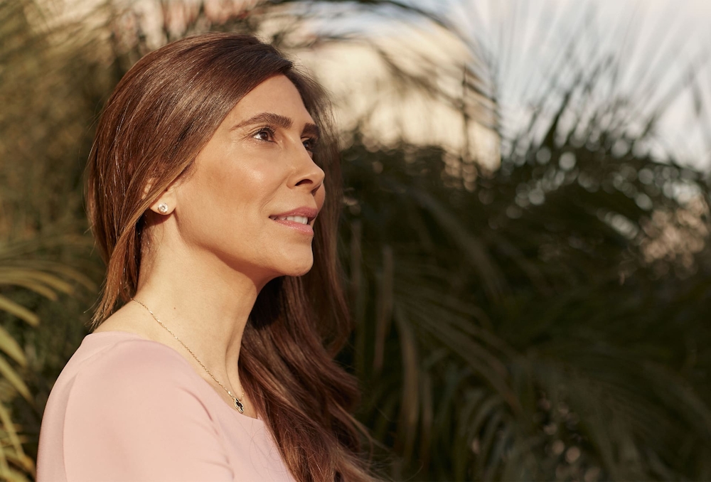 patient in front of palm tree looking to the right