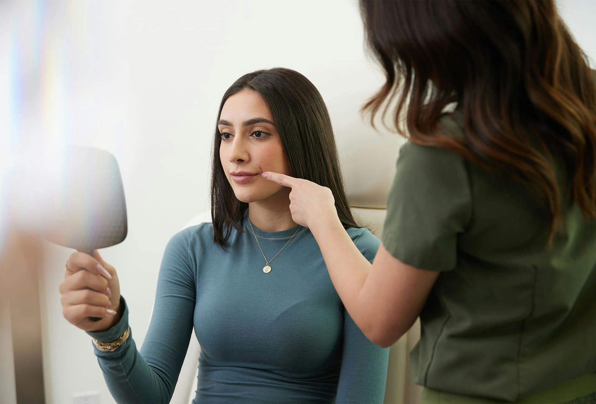 nurse pointing to patient's lip